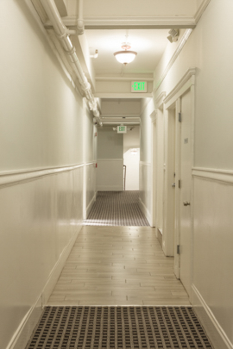 a long, white hallway with doors on either side